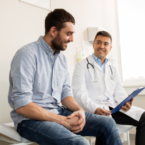 Doctor discussing test results with smiling male patient hormone replacement therapy