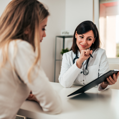Doctor consulting with female patient in office hormone replacement therapy